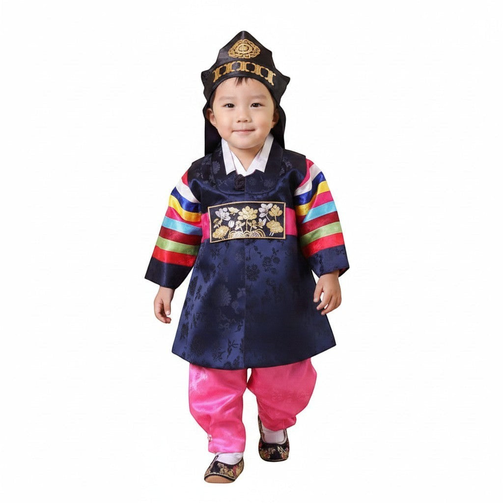 Little Seouls traditional navy blue silk dolbok prince hanbok for a 1st birthday, with pink pants and colorful striped sleeves.