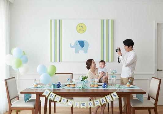 Little Seouls 100th Day Baek-il celebration banner with a blue elephant and green & blue stripes.