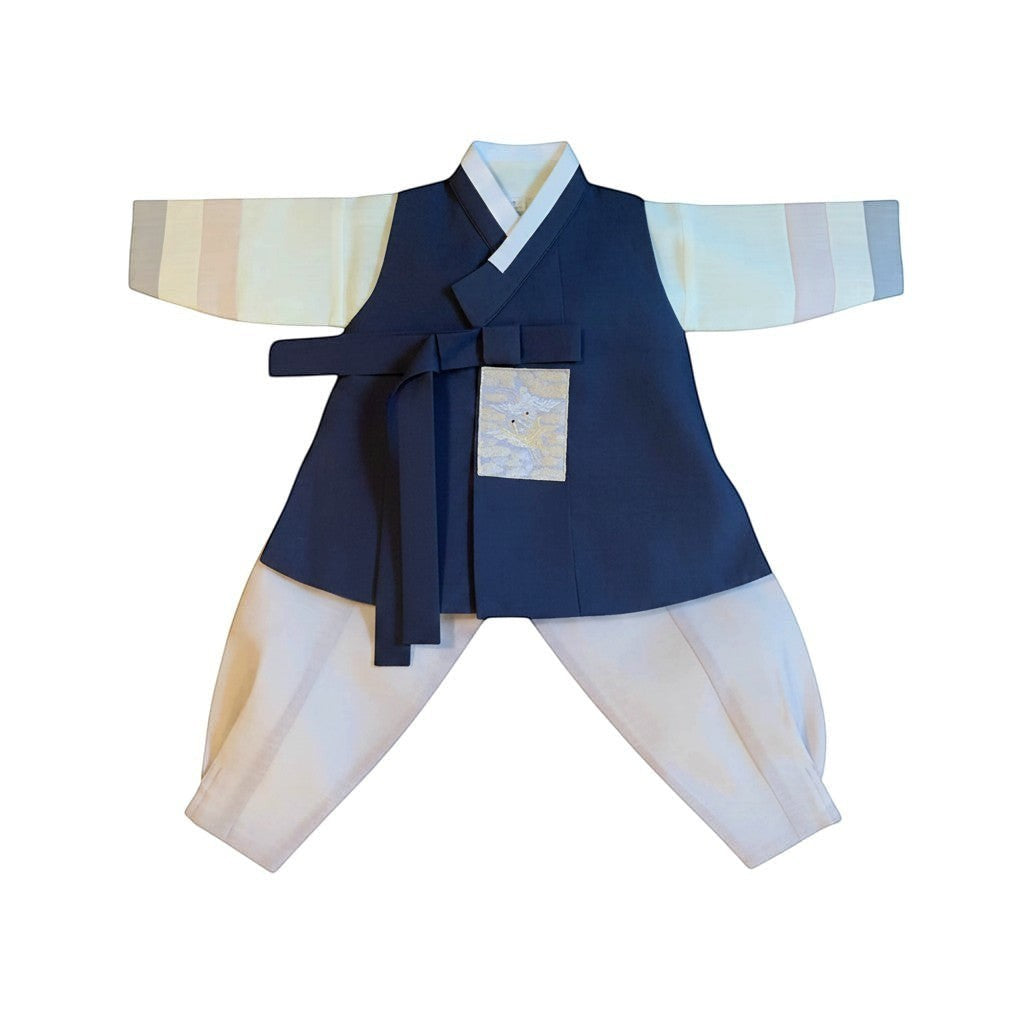 Little Seouls navy blue and cream hanbok for a 1st birthday boy, with embroidered crane detail.