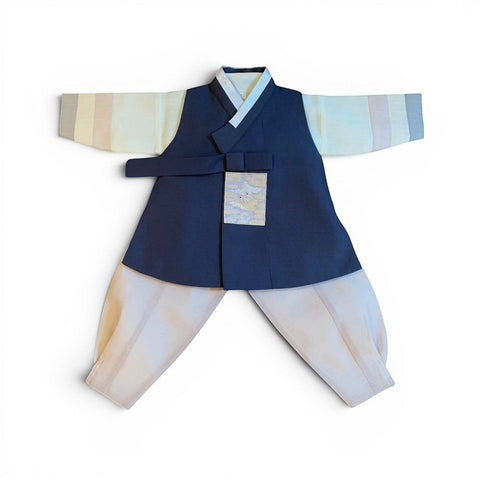 Little Seouls navy blue and cream 1st birthday boy hanbok with embroidered pocket detail and striped sleeves.