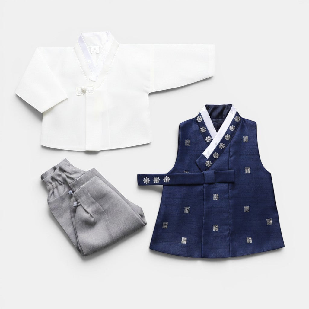 Little Seouls Traditional Korean Baby Hanbok Set: white top, navy vest with silver floral patterns, grey pants.