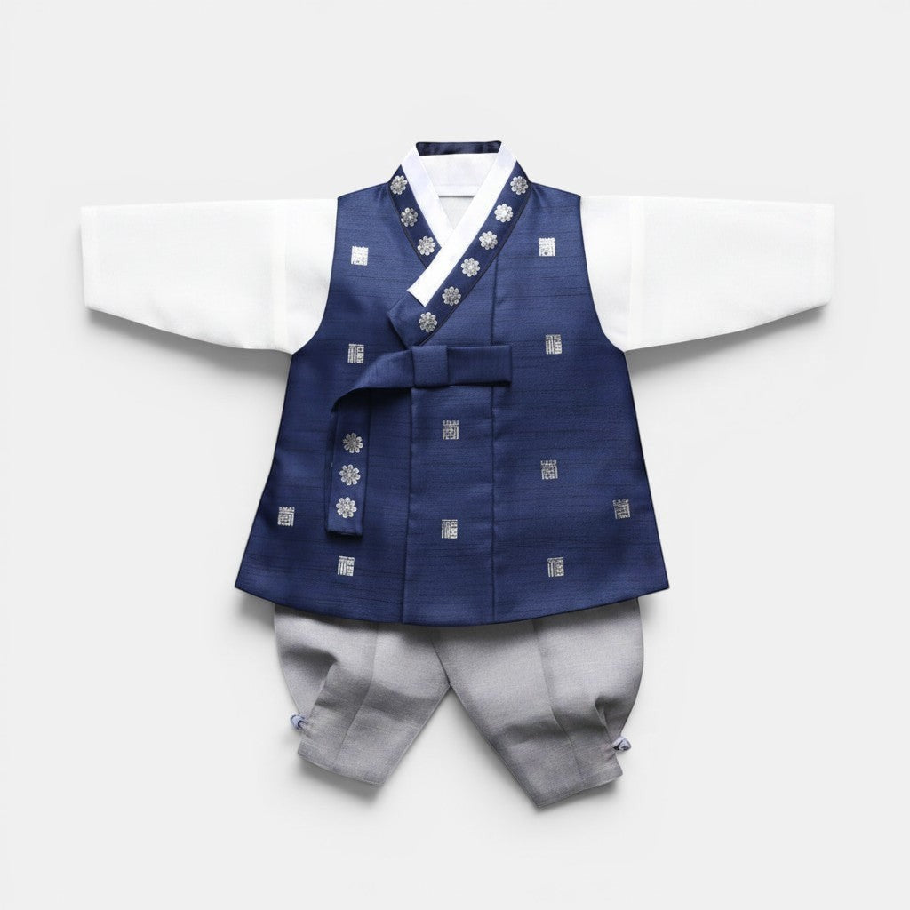Little Seouls Traditional Korean Baby Hanbok Set: white top, navy vest with silver floral & square patterns, ribbon tie, grey pants.