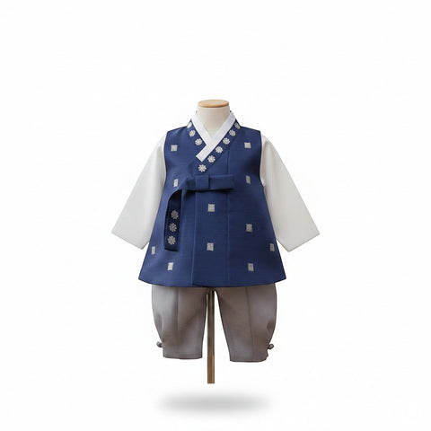 Little Seouls Traditional Korean Baby Hanbok Set: white top, navy vest with silver floral patterns, grey pants. Traditional ribbon tie.