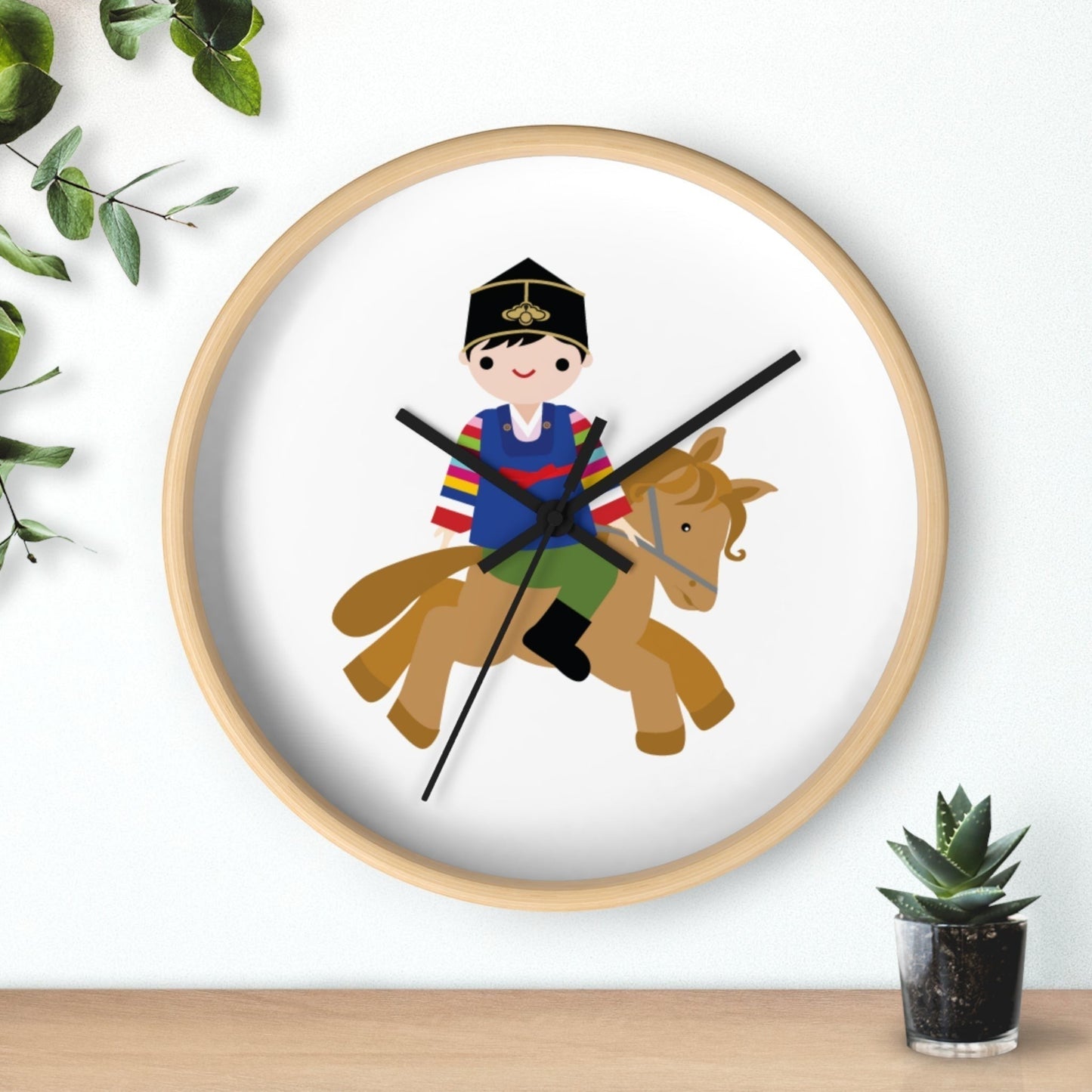 Little Seouls wooden wall clock with a cheerful illustration of a child in folk dress riding a horse. Natural wood frame.