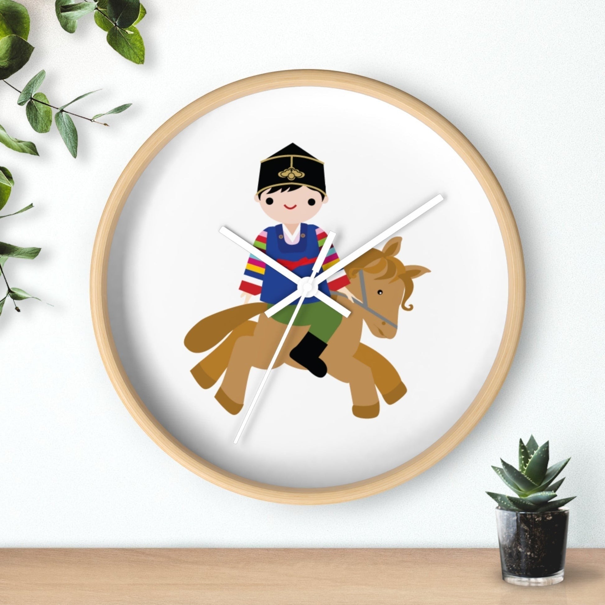 Little Seouls wooden wall clock with a boy in colorful folk dress riding a horse illustration. Natural wood frame.