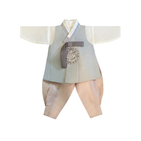 Little Seouls modern Seoul hanbok for a 1st birthday boy. Features a pale blue vest with grey trim and sash, white shirt, and pale pink pants. Includes headpiece.