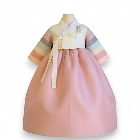 Little Seouls pink 100th day Hanbok for baby girls, featuring a white top with pastel rainbow sleeves and a full pink skirt.