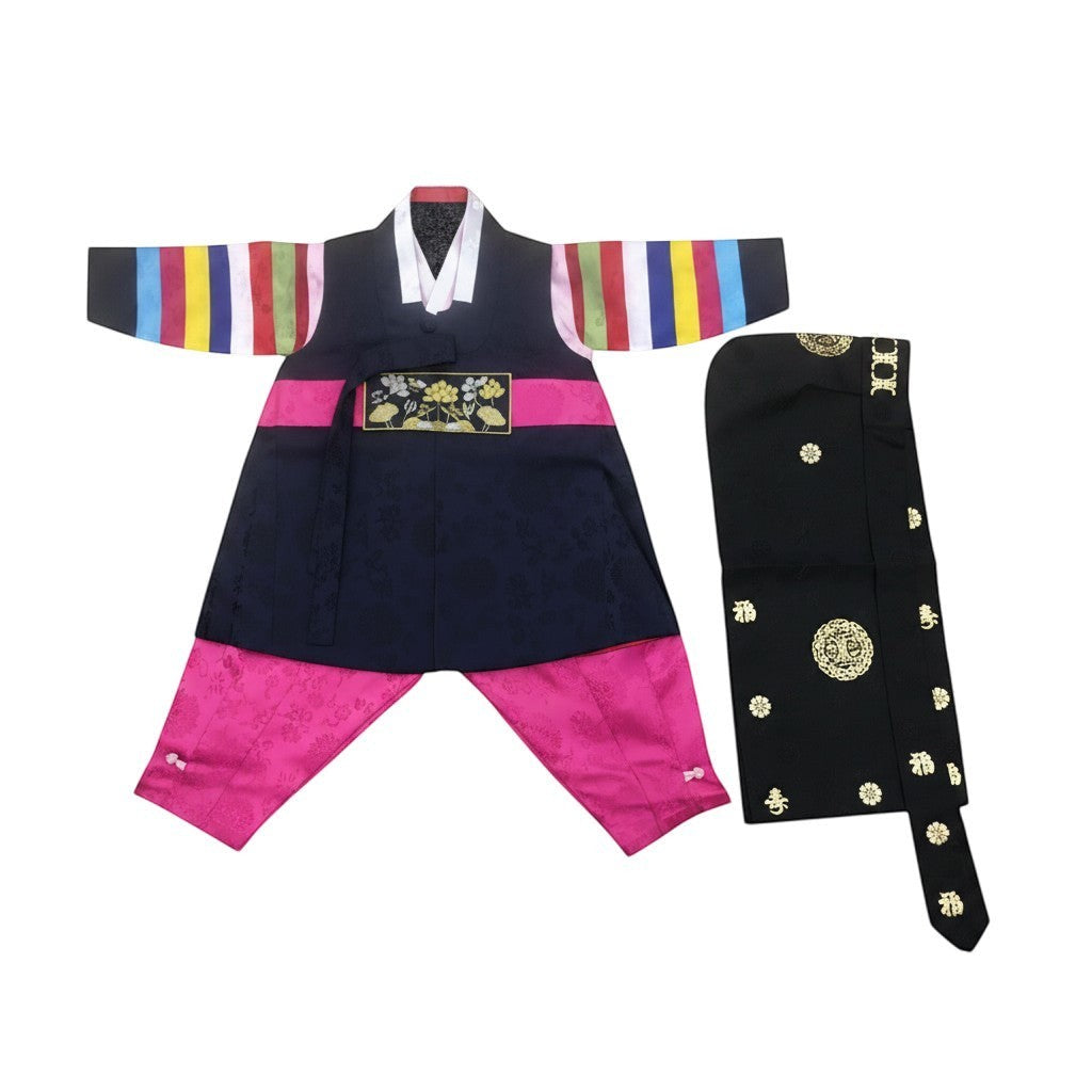 Little Seouls traditional navy blue and pink dolbok hanbok for a 1st birthday boy, featuring colorful striped sleeves and gold embroidery.