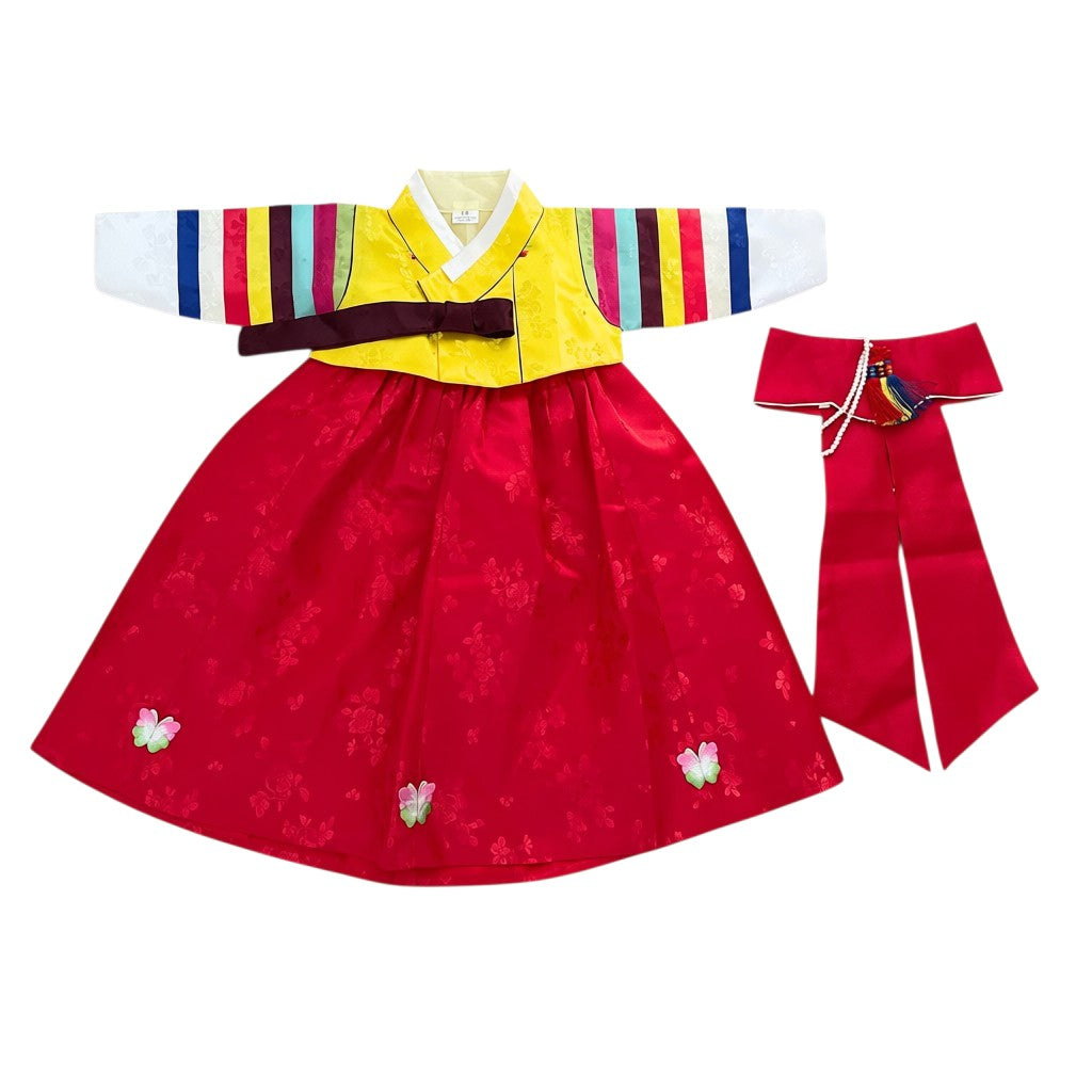 Little Seouls 1st birthday girl's traditional yellow and red Hanbok with embroidered butterflies on skirt and colorful striped sleeves.
