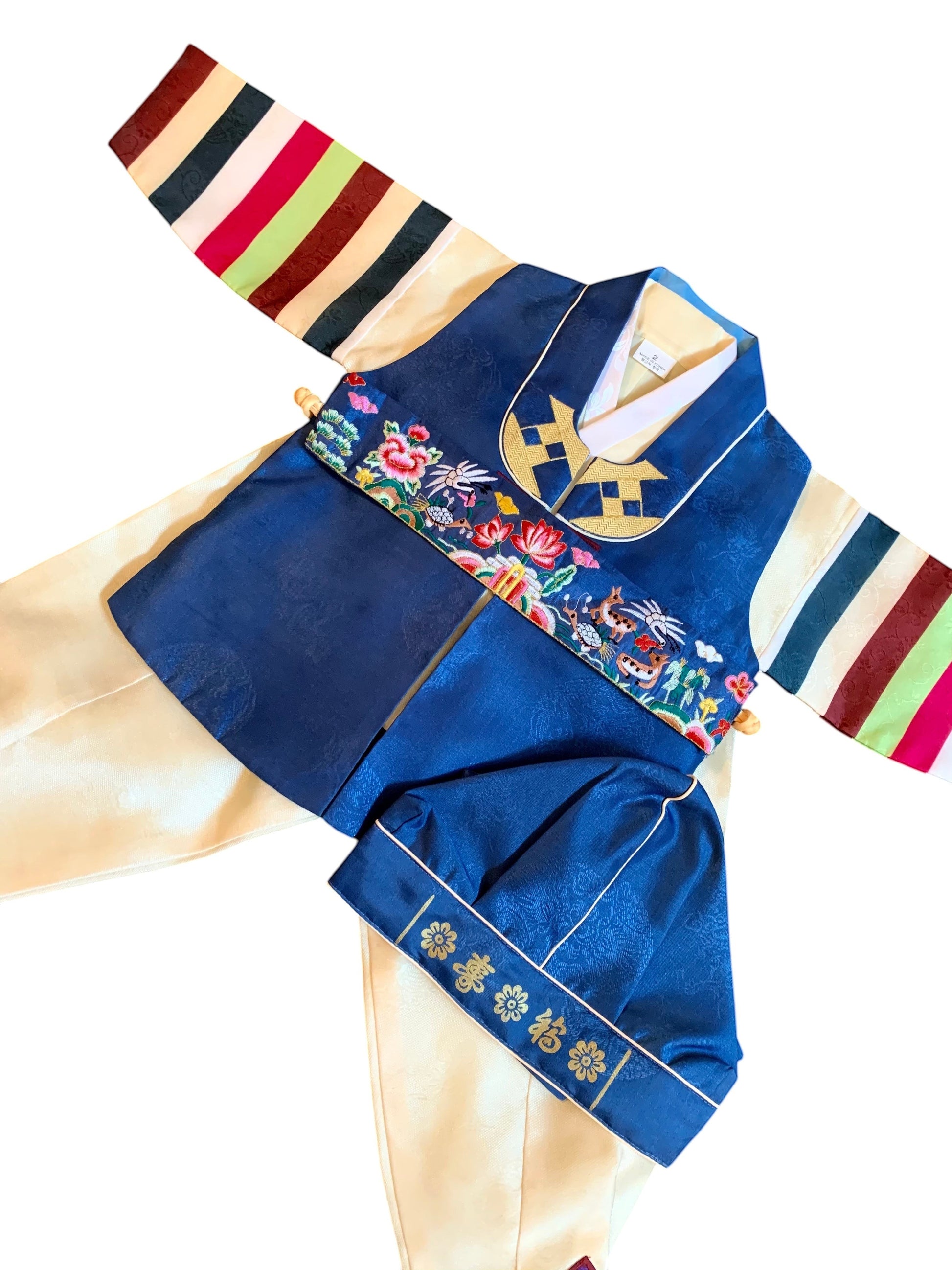 Little Seouls traditional blue and yellow hanbok for a 1st birthday boy. Includes embroidered floral details and colorful striped sleeves.