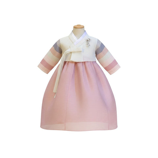 Little Seouls 1st birthday girl's pink and white hanbok with striped sleeves and a floral brooch.
