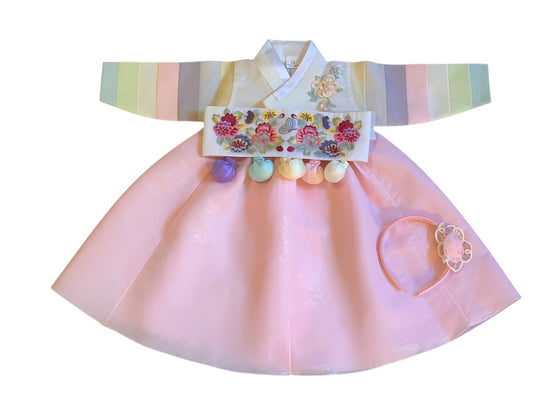 Little Seouls pink satin hanbok for 1st birthday girl, featuring embroidered flowers and pastel striped sleeves.