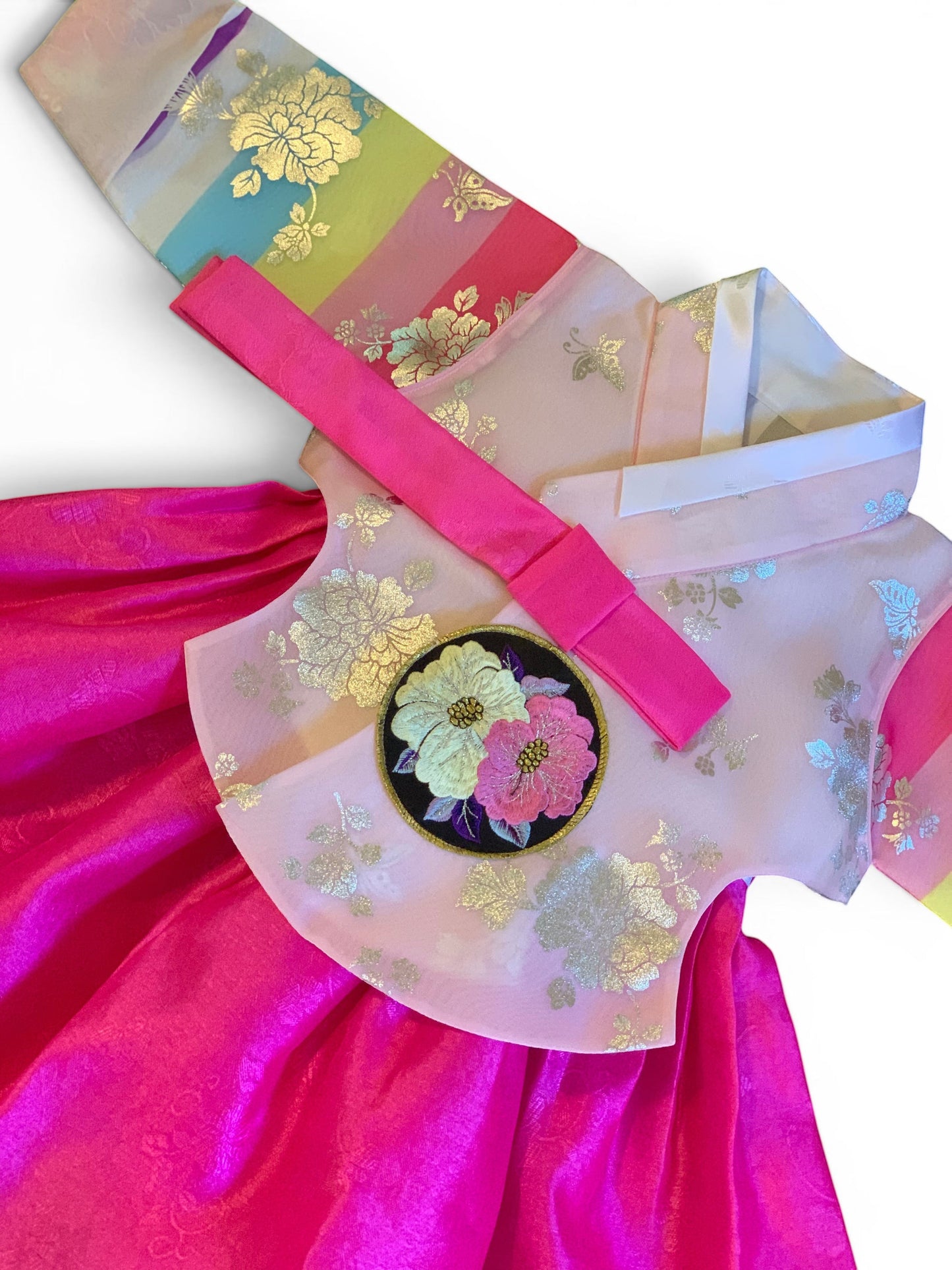 Little Seouls pink and fuchsia traditional Korean hanbok for a 1st birthday girl, size 12-18 months. Features floral embroidery and a rainbow sash.