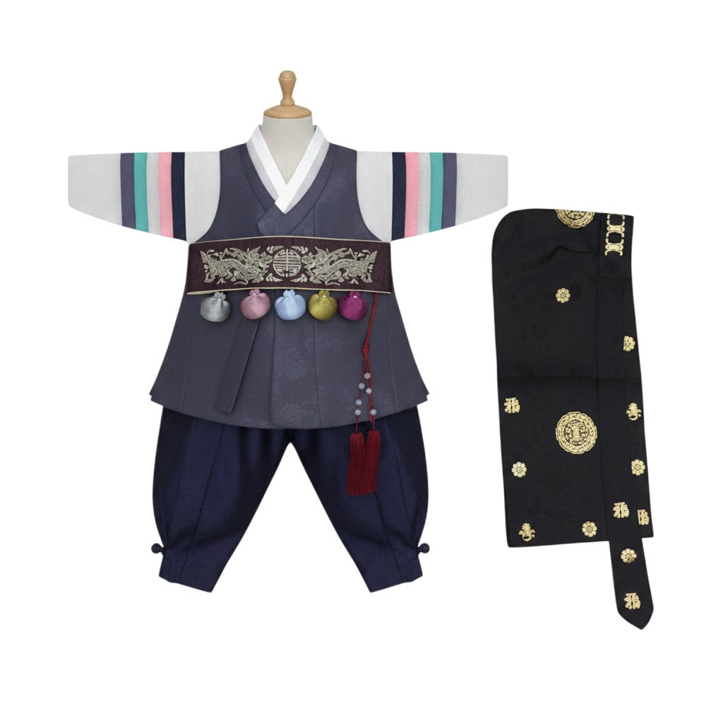 Little Seouls traditional plum and navy blue dolbok hanbok for a 1-year-old boy. Features colorful sleeve stripes and ornate gold belt.