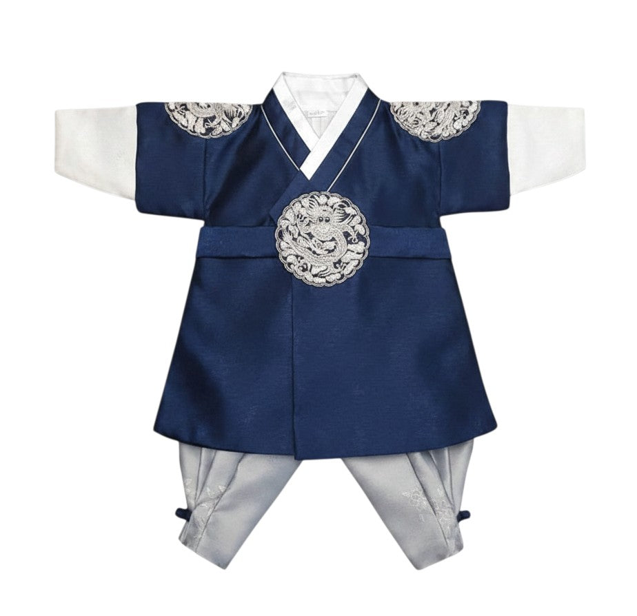Little Seouls royal blue and silver Korean hanbok for a 1st birthday boy, featuring dragon embroidery and a matching headpiece.