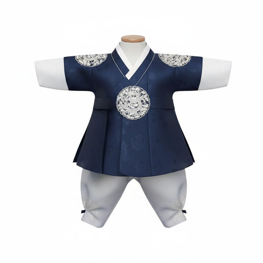 Little Seouls navy blue royal king style hanbok for a 1st birthday boy, with white pants and ornate silver dragon detail.