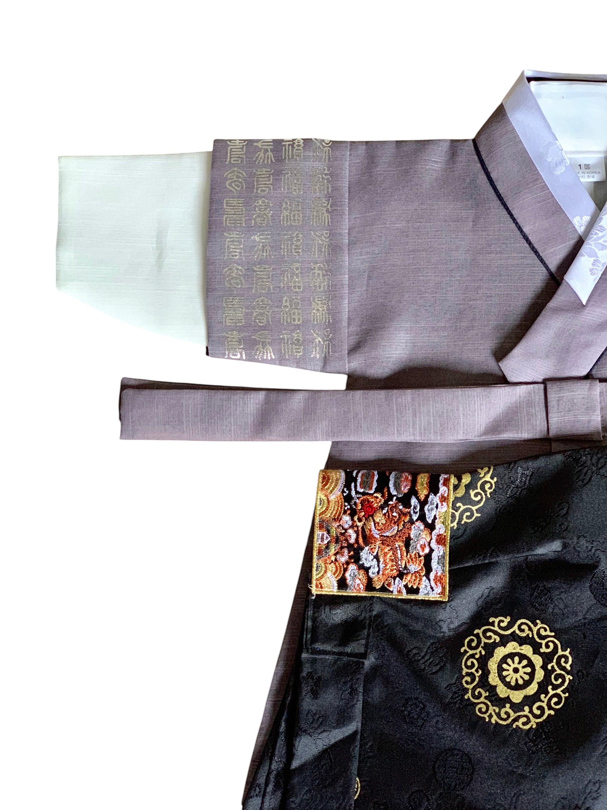 Little Seouls traditional grey and white boy's 1st birthday Hangul hanbok with ornate gold embroidery and a black skirt.